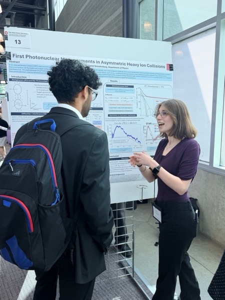 Julie Scherzer explaining her analysis to symposium visitors
